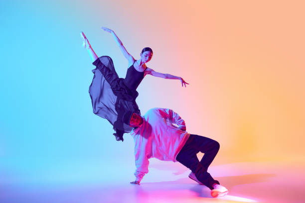 istock Artistic Synergy. Two dancers from different worlds find harmony in their contrasting styles, girl, ballerina dancing with man, break dancer 2155514559