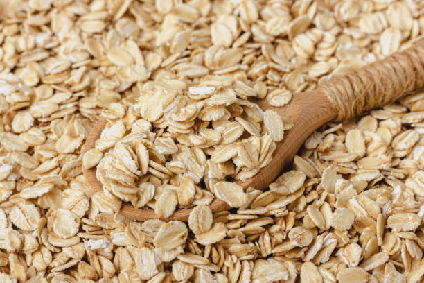 istock Oat flakes with wooden spoon. 2155515093