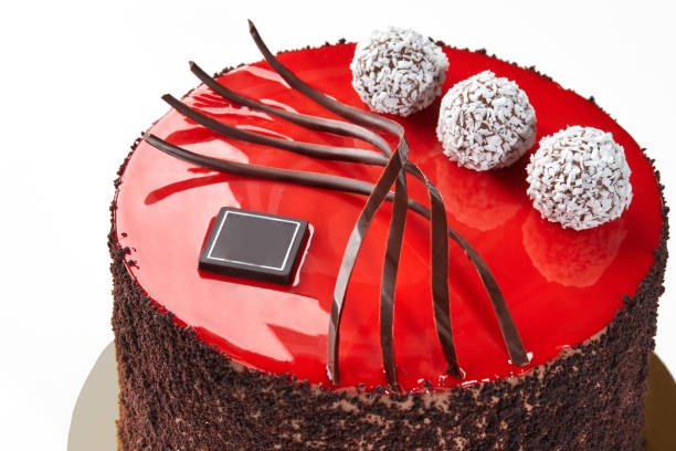 red velvet cake with strawberry and chokolate cookie and cup of tea on the brown wooden table in a cafe summer veranda. Image is  close up