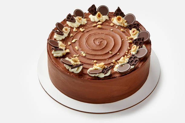 istock Elegant honey chocolate cake with whipped cream and hazelnuts 2155515253