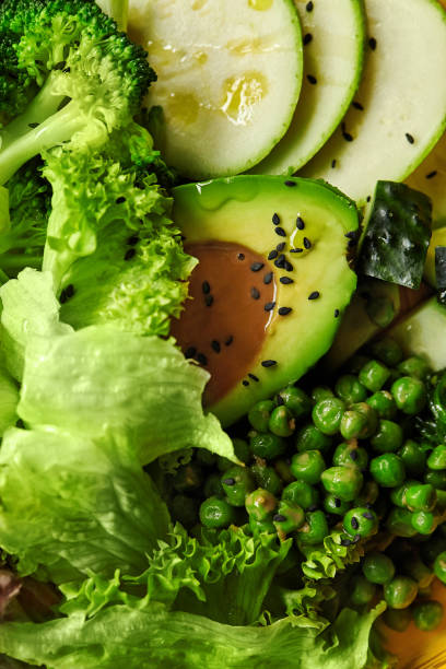 istock Green vegetarian salad with fresh vegetables, avocado and peanut dressing 2155515283