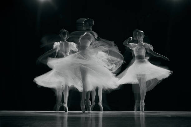 istock Blurred, dynamic image of beautiful, tender ballerinas in motion, their white tutus forming ethereal shapes as they dance. 2155519971