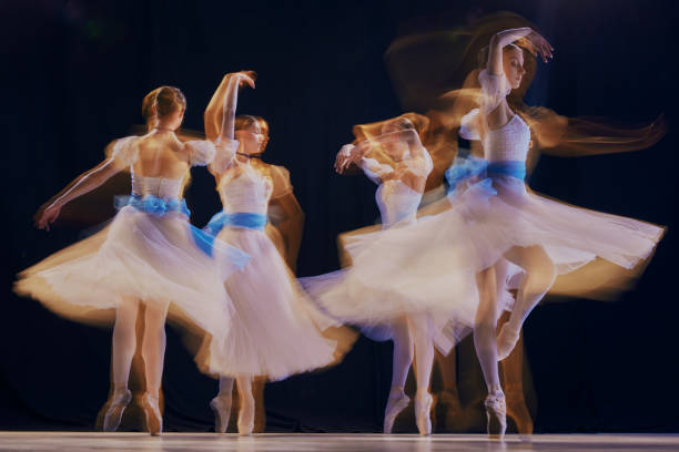 istock Artistic image of four ballerinas, their synchronized movements forming beautiful blur of white tutus and grace. 2155519982