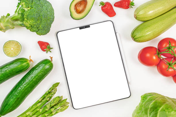 istock Digital tablet computer with mockup white screen on vegetarian healthy food vegetable background 2155520734