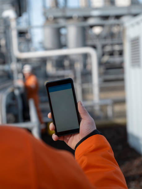 istock Industrial Worker with Smartphone at Electrical Installation Site 2155521030
