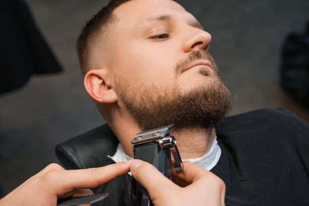 istock Man during the procedure of cutting beard. 2155522088
