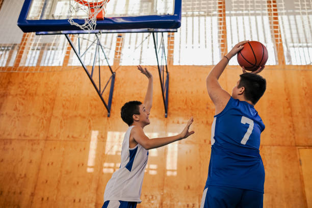 istock Junior basketball player is shooting at the hoop at training. 2155522784