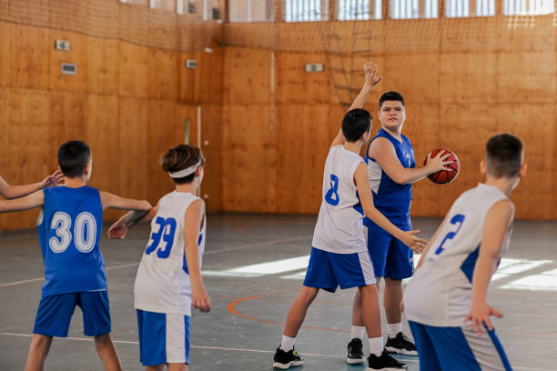 istock A junior basketball players practicing basket on training at court. 2155522785