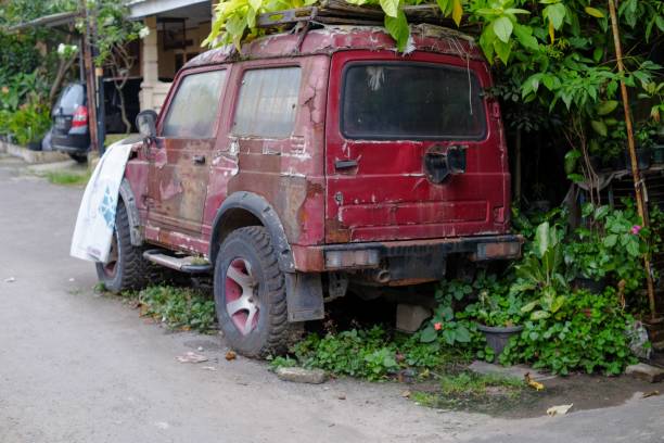 istock Rusty abandoned red car on the garden home 2155522897