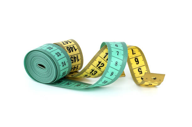 istock Green and yellow measuring tape isolated on white background 2155524049