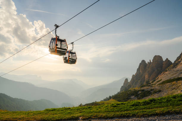 Cable car in Dolomites at sunset Scenic view of cable car in Dolomites at sunset gondola stock pictures, royalty-free photos & images