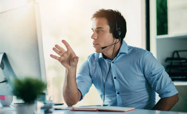 istock Customer service, phone call and man with headset, computer and consulting at help desk. Lead generation, conversation and advice at callcenter for telemarketing, sales and online account support. 2155526071