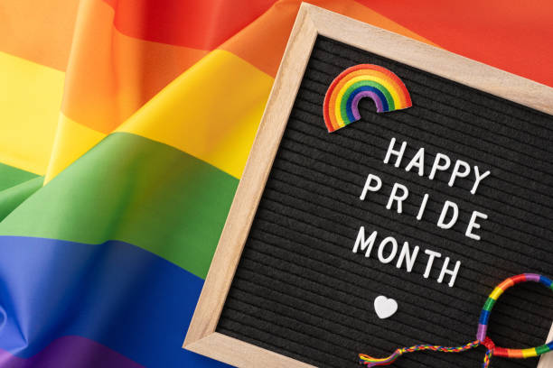 istock A colorful display celebrating Pride Month with a vibrant rainbow flag and a message board expressing support and love 2155526449