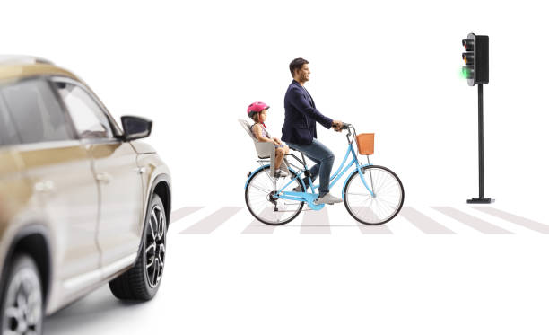 istock Father riding a child with a bicycle at a pedestrian crossing 2155527010