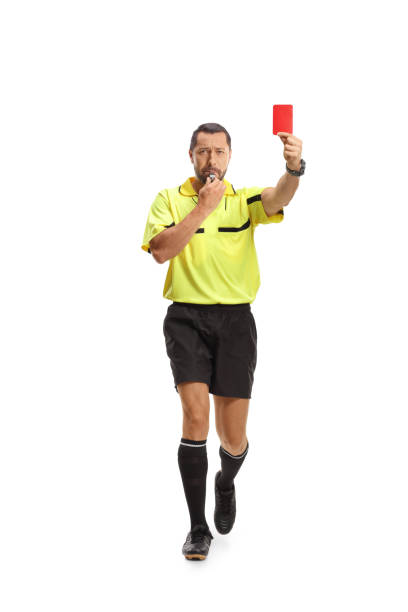 istock Football referee running with a red card and blowing a whistle 2155527041