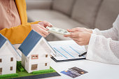 asian-businesswoman-discusses-home-purchase-contracts-with-clients-at-her-desk-focusing-on.jpg?b=1&s=170x170&k=20&c=j5qK2q4yK1RoTtg9ptlFQ_9un2SDDPYAsG5AQ7M221s=
