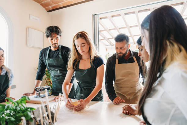 istock People are enjoying a cooking class to learn how to make homemade pasta 2155528983