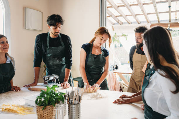 istock People are enjoying a cooking class to learn how to make homemade pasta 2155528997
