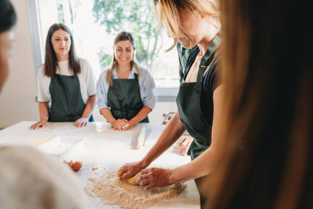 istock People are enjoying a cooking class to learn how to make homemade pasta 2155529000