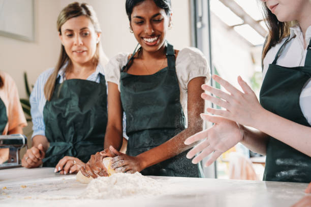 istock People are enjoying a cooking class to learn how to make homemade pasta 2155529014