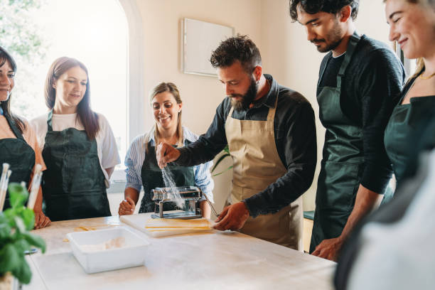 istock Participants of a cooking class are learning how to make homemade pasta 2155529017