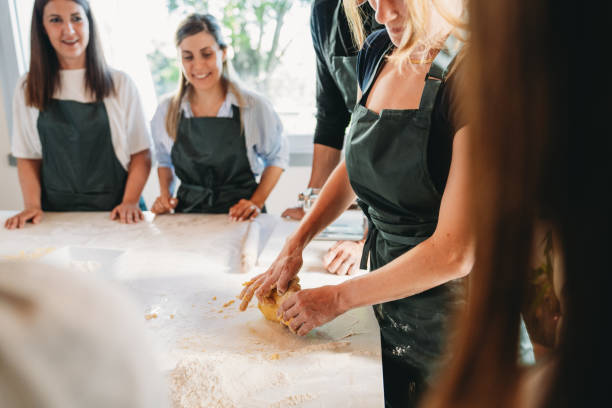 istock People are enjoying a cooking class to learn how to make homemade pasta 2155529026