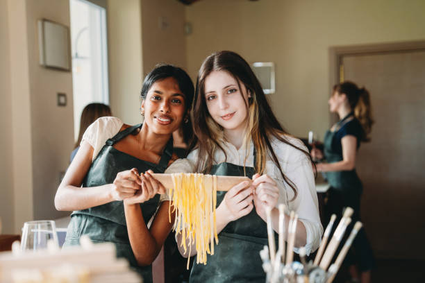 istock Portrait of two friends after a cooking class 2155529063