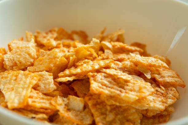 Close up of salty flavored chips in a white bowl