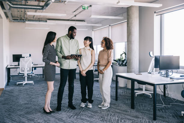 istock Multi ethnic colleagues, sharing ideas at the office 2155530158