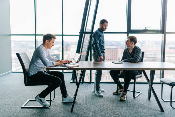 istock A team of young professionals hard at work on a project, all typing on their laptops 2155530605