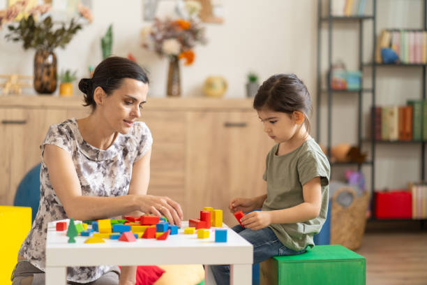 istock Woman and child playing with blocks 2155530630