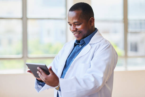 istock Happy Doctor Using Digital Tablet in Hospital Office 2155531157