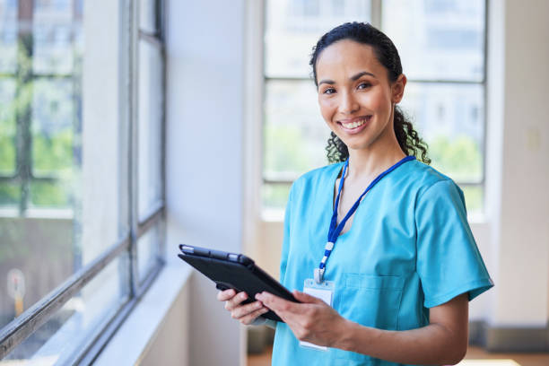 istock Smiling Female Nurse with Tablet in a Hospital Setting 2155531231