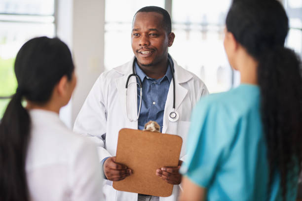 istock Multi-Ethnic Medical Team in Discussion at Hospital 2155531232