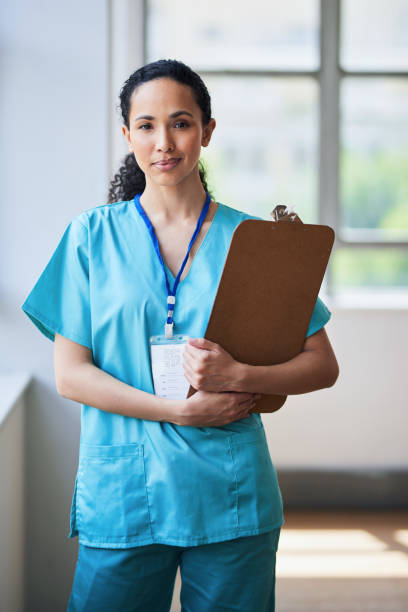 istock Confident Female Nurse Holding Clipboard in Hospital Setting 2155531268