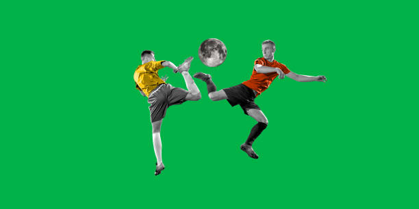 Creative game. Two young men, soccer players in uniform playing with moon instead ball on green background. Contemporary art collage.