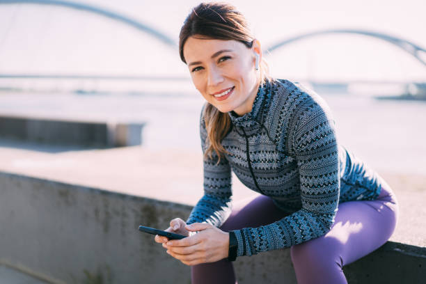 istock Sporty woman using smart phone outdoors. 2155533267