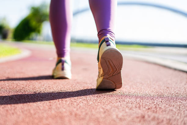 Rear view of runner shoes on a running track.