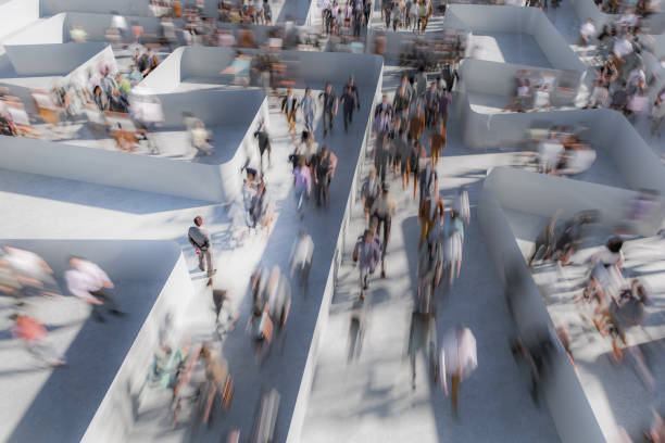istock Businessman watching people running in a maze 2155533301
