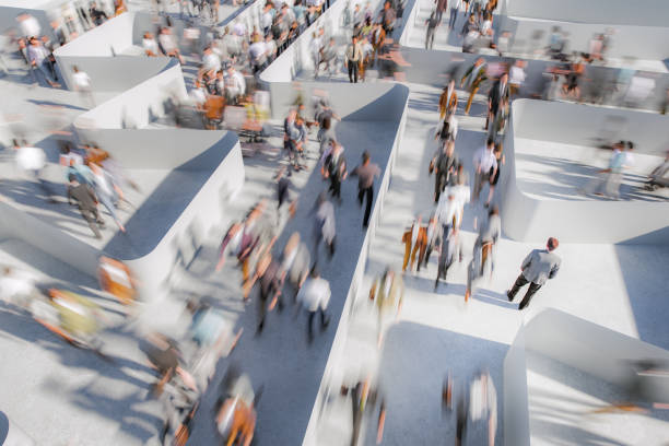 istock Businessman watching people running in a maze 2155533477