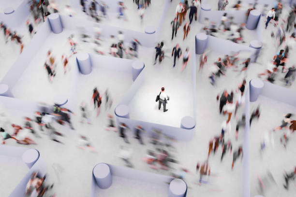 istock Businessman watching people running in a maze 2155533515