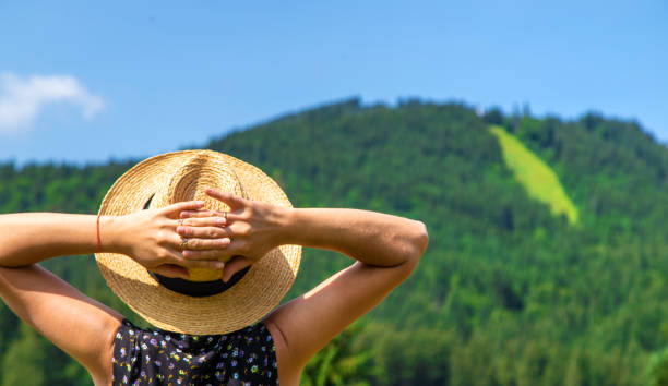 A woman in the mountains admires nature. Selective focus. Nature.