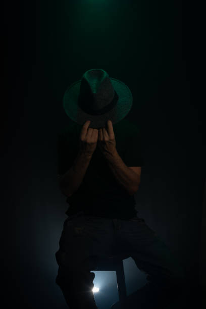istock Mysterious, bearded man wearing a hat posing for the camera. Studio portrait. 2155534334