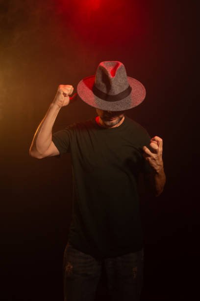 istock Mysterious man wearing hat standing posing for photo. Studio portrait. 2155534339