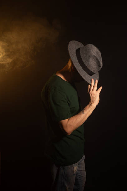 istock Mysterious man wearing hat standing posing for photo. Studio portrait. 2155534346