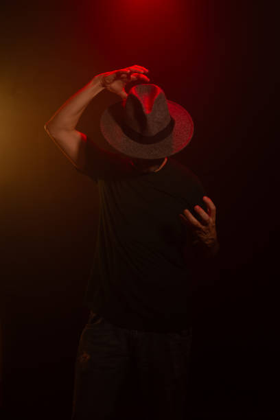 istock Mysterious man wearing hat standing posing for photo. Studio portrait. 2155534353