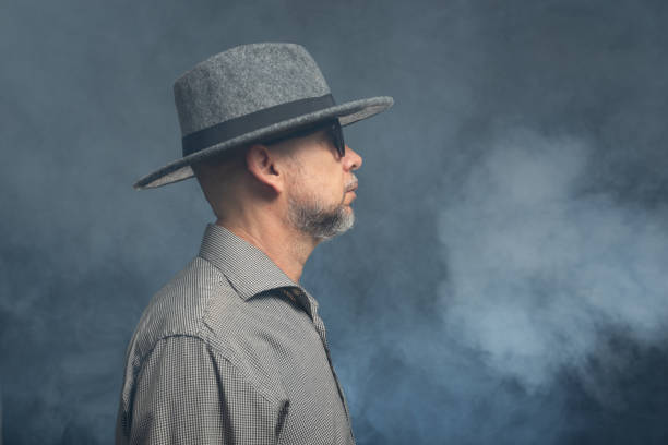 istock Middle-aged man with a beard wearing a hat and posing for the camera. 2155534378
