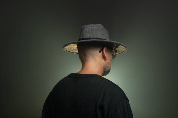 istock Mysterious, middle-aged man wearing a hat on his head. Photo in studio. 2155534413