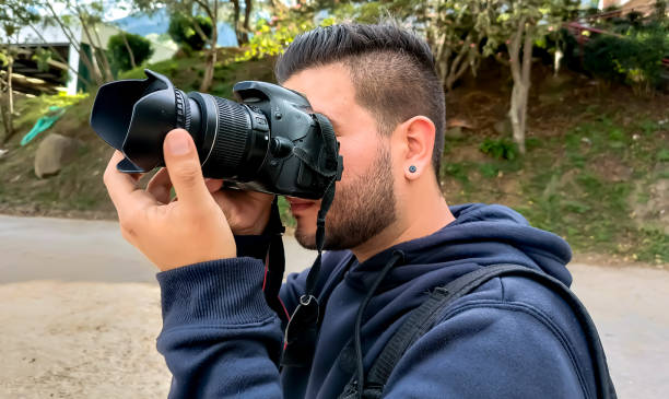 istock young latin photographer with camera in hand 2155536470