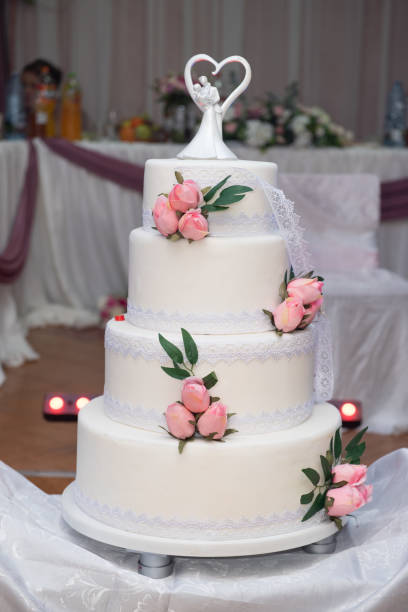 istock White wedding cake decorated with pink roses 2155536540